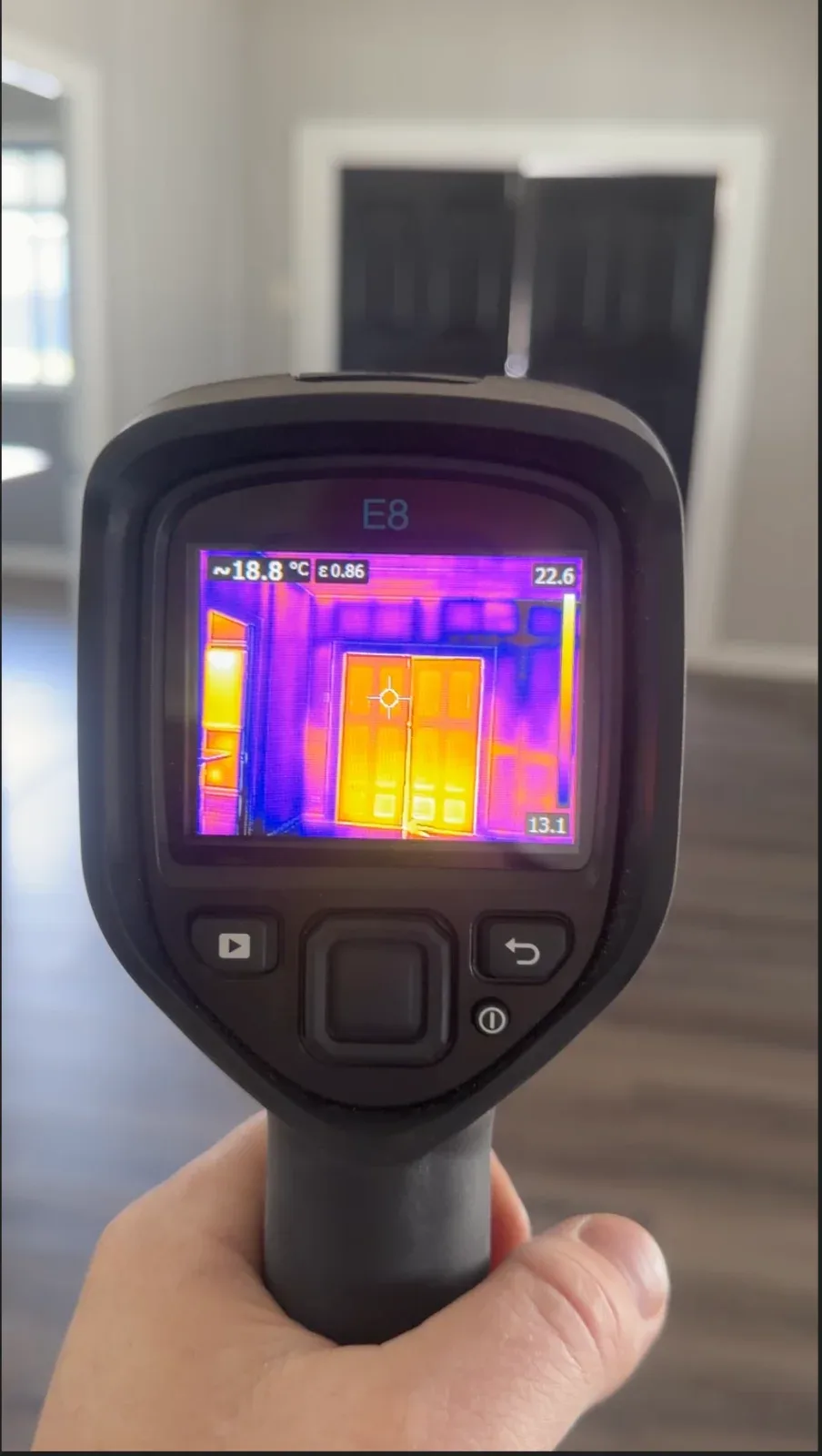 Thermal imaging camera showing heat loss around a door during an Elite inspection