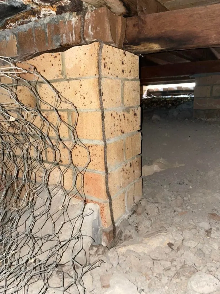 Brick pier and timber bearers in the subfloor of a house